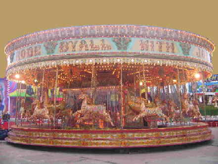 An image of a full sized Victorian carousel, one of the most ornate and spectacular rides available on the British fairground.